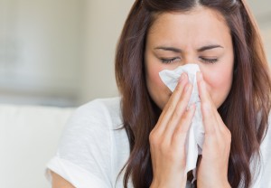 woman blowing nose into tissue