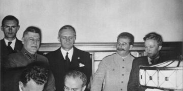 Molotovo–Ribbentropo paktas: V. Molotovas pasirašo Vokietijos ir SSRS sutartį, šalia – I. Ribbentropas ir J. Stalinas
